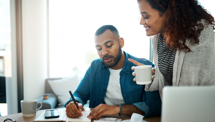 Couple discussing and planning how to maximize their savings.