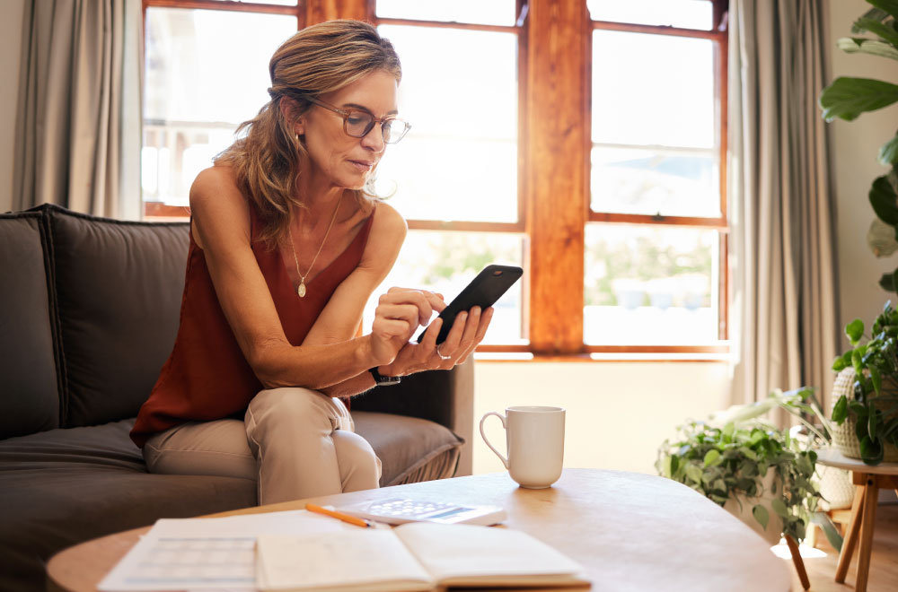 Woman looking at Civista Bank's savings account options on her phone.